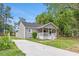View of the home and freshly poured concrete driveway at 128 W Parker St, Henderson, NC 27536