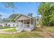 Inviting home exterior with a cozy porch and a well-maintained lawn at 128 W Parker St, Henderson, NC 27536