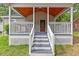Cozy front porch with wooden ceiling, providing a warm welcome at 128 W Parker St, Henderson, NC 27536