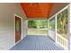Spacious front porch with a wooden ceiling, enhancing curb appeal at 128 W Parker St, Henderson, NC 27536