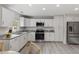 Stylish kitchen featuring white cabinets, stainless appliances, and granite countertops at 128 W Parker St, Henderson, NC 27536