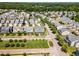 A high aerial view of houses in a neighborhood with tree lined streets on a sunny day at 1304 Revolution Cir, Raleigh, NC 27603