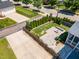 Aerial view of the backyard, pavers, and screened in porch of a well manicured lawn at 1304 Revolution Cir, Raleigh, NC 27603