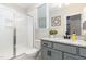 Modern bathroom with grey cabinets, granite counter, glass enclosed shower and toilet at 1304 Revolution Cir, Raleigh, NC 27603