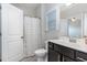 Well-lit bathroom with a dark wood vanity and a shower/tub combo featuring a white shower curtain at 1304 Revolution Cir, Raleigh, NC 27603