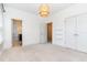 A spacious bedroom with neutral carpet, featuring an ensuite bathroom and walk-in closet at 1304 Revolution Cir, Raleigh, NC 27603