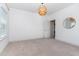 A bright and airy bedroom featuring neutral walls and carpet, with a decorative circular mirror at 1304 Revolution Cir, Raleigh, NC 27603