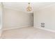 A simple bedroom with neutral walls and carpet, with a simple light fixture and empty wall baskets at 1304 Revolution Cir, Raleigh, NC 27603