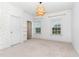 Bright bedroom with two windows, patterned accent wall, and unique decorative pendant light at 1304 Revolution Cir, Raleigh, NC 27603