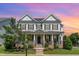 Charming two-story home with stone accents, inviting front porch, and manicured landscaping at 1304 Revolution Cir, Raleigh, NC 27603