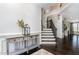 Elegant foyer with hardwood floors, staircase, and decorative console table at 1304 Revolution Cir, Raleigh, NC 27603