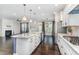 Open concept kitchen with stainless appliances, granite countertops, and a view of the cozy living room at 1304 Revolution Cir, Raleigh, NC 27603