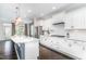 Well-lit kitchen with granite countertops, stainless steel appliances, and a view of the outdoor patio at 1304 Revolution Cir, Raleigh, NC 27603