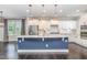 The modern kitchen boasts stainless steel appliances, a large island, and stylish pendant lighting at 1304 Revolution Cir, Raleigh, NC 27603