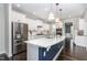 Bright kitchen with white cabinets, stainless steel appliances, a center island, and lovely marble countertops at 1304 Revolution Cir, Raleigh, NC 27603