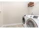 Bright laundry room with new appliances and convenient shelf with basket for easy storage at 1304 Revolution Cir, Raleigh, NC 27603