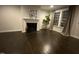 Inviting living room features dark hardwood floors, fireplace, and large windows providing natural light at 1304 Revolution Cir, Raleigh, NC 27603
