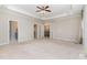 Spacious main bedroom with a tray ceiling, ceiling fan, and multiple doorways to adjoining rooms at 1304 Revolution Cir, Raleigh, NC 27603