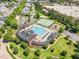 Aerial view of the community pool, tennis court, playground and surrounding neighborhood at 1304 Revolution Cir, Raleigh, NC 27603