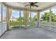 Relaxing screened porch featuring ceiling fan, decorative curtains, and views of the landscaped backyard at 1304 Revolution Cir, Raleigh, NC 27603
