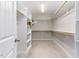 Walk-in closet with shelving, rods, and carpeted floor, offering ample storage space at 1304 Revolution Cir, Raleigh, NC 27603
