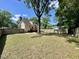Spacious backyard with a house, deck, large tree, wooden fence, and storage shed at 1305 Shakentown St, Knightdale, NC 27545