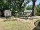 Spacious backyard with a storage shed, a swing set, and a mature tree at 1305 Shakentown St, Knightdale, NC 27545