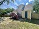 Backyard featuring a wood deck, side-entry green door, privacy fence, and mature trees at 1305 Shakentown St, Knightdale, NC 27545