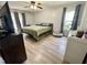 Comfortable bedroom with natural light, wood-look floors, a ceiling fan, and neutral decor at 1305 Shakentown St, Knightdale, NC 27545