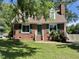 Charming brick home with dormer windows, green shutters, and a neatly landscaped front yard at 1305 Shakentown St, Knightdale, NC 27545