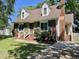 Beautiful brick home with a well-manicured lawn, dormer windows, and a classic brick chimney at 1305 Shakentown St, Knightdale, NC 27545