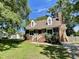 Charming brick home featuring dormer windows, green shutters, a brick chimney, and a lush front yard at 1305 Shakentown St, Knightdale, NC 27545