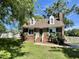 Charming brick home featuring dormer windows, green shutters, and a well-maintained lawn at 1305 Shakentown St, Knightdale, NC 27545