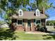 Charming brick home with dormer windows, green shutters, and a well-manicured front lawn at 1305 Shakentown St, Knightdale, NC 27545