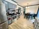Modern kitchen with gray cabinets, stainless steel appliances, and a dining area nearby at 1305 Shakentown St, Knightdale, NC 27545