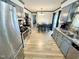 Well-lit kitchen with stainless steel appliances, a dining table, and wood-look floors at 1305 Shakentown St, Knightdale, NC 27545