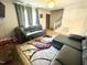 Living room featuring a gray couch, wood flooring, and a colorful area rug at 1305 Shakentown St, Knightdale, NC 27545
