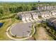 An aerial shot showcases the townhome community's layout, featuring a pond and trees at 136 Ashlar Ct, Cary, NC 27519