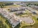 Aerial view of a neighborhood with townhomes, green spaces, and winding streets at 136 Ashlar Ct, Cary, NC 27519
