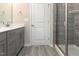 Bathroom featuring a gray vanity, glass doored shower and tile flooring at 136 Ashlar Ct, Cary, NC 27519