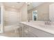 Well-lit bathroom boasts a double sink vanity, tub-shower combination, and neutral finishes, offering a clean and functional space at 136 Ashlar Ct, Cary, NC 27519