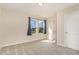 Inviting bedroom features soft carpeting, ample natural light from a pair of windows, and a convenient closet, creating a cozy atmosphere at 136 Ashlar Ct, Cary, NC 27519