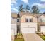 Attractive townhome with a covered front door, single car garage, and manicured front yard at 136 Ashlar Ct, Cary, NC 27519