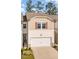 Charming townhome exterior featuring a two-car garage, neutral siding, and welcoming front entrance with fresh landscaping at 136 Ashlar Ct, Cary, NC 27519