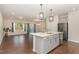 Open-concept kitchen with a central island, stainless steel appliances, and modern lighting, ideal for cooking and entertaining at 136 Ashlar Ct, Cary, NC 27519