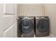 Efficient laundry room equipped with modern Samsung washer and dryer, along with built-in shelving for added storage at 136 Ashlar Ct, Cary, NC 27519