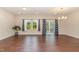 Living room featuring hardwood floors, large windows, and decorative curtains at 136 Ashlar Ct, Cary, NC 27519