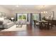 Open living and dining area with hardwood floors, large windows, and stylish decor at 136 Ashlar Ct, Cary, NC 27519