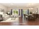 Bright, staged living and dining area with wood floors and plenty of natural light at 136 Ashlar Ct, Cary, NC 27519