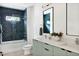 Stylish bathroom featuring blue honeycomb tiles, a double vanity, and a modern design at 1405 Watts St, Durham, NC 27701